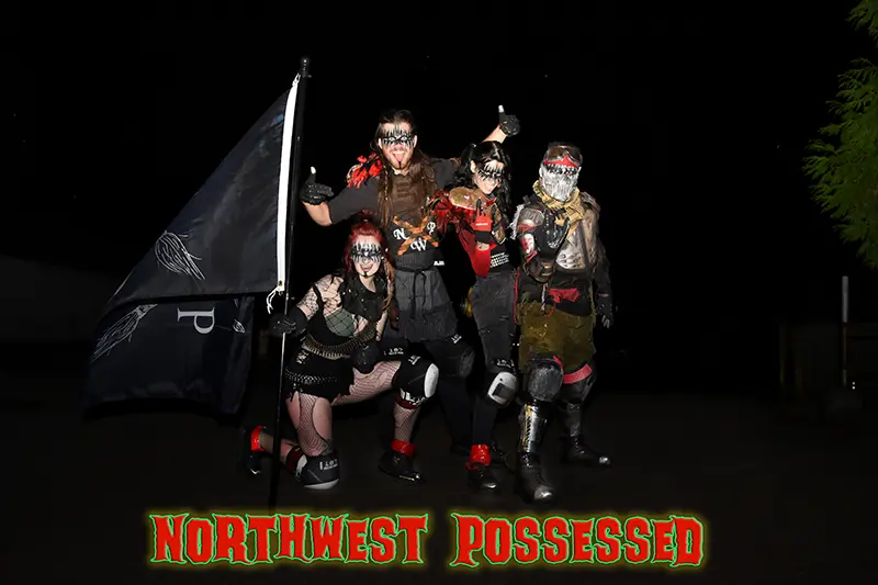 A group of individuals are seen carrying a flag inscribed with the phrase "Northwest Possessed.