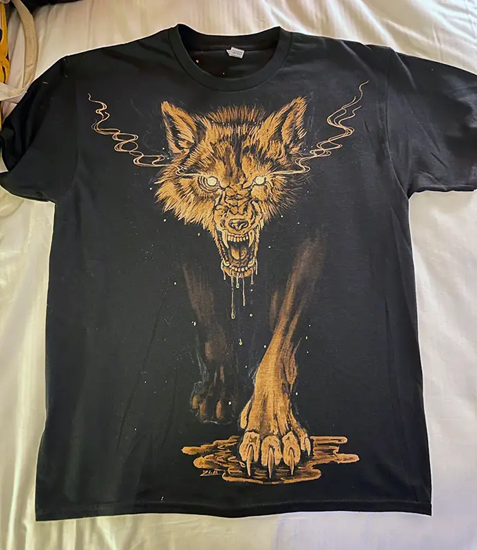 A black t-shirt adorned with an entrancing image of a wolf.