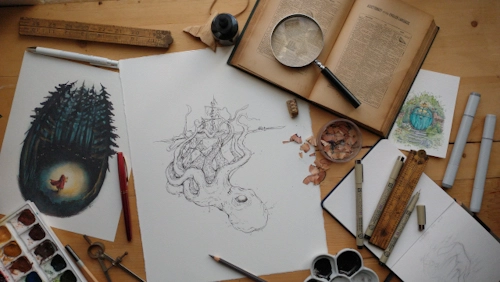 A table displays a series of octopus sketches, accompanied by an open book and a magnifying glass.