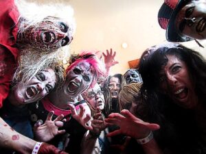 A group of people in Seattle dressed as zombies, reaching toward the camera with exaggerated expressions—straight out of a thriller!.