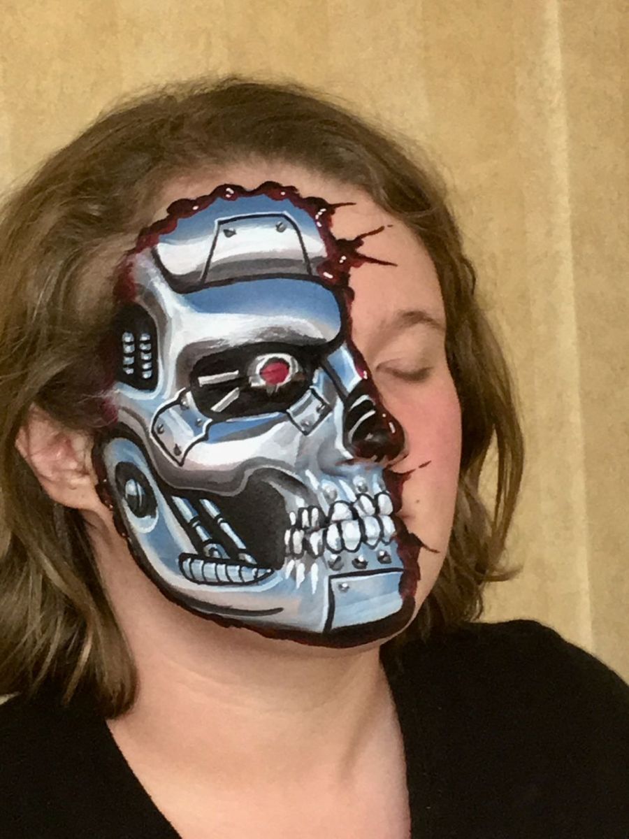 Dutch-inspired makeup application reveals a half-exposed robot skull, eyes closed, against a neutral background.