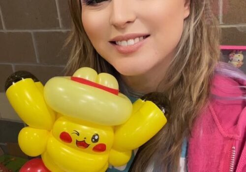 Smiling woman with face painting holds a Pikachu balloon. Text reads “Tiny Art Face Painting.”.