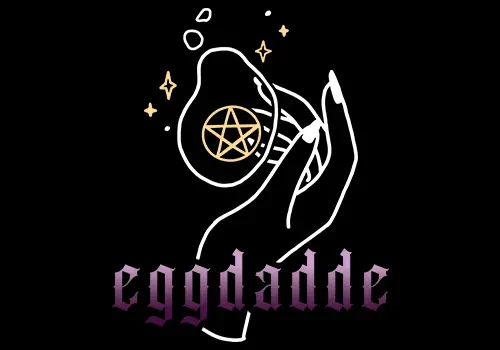 A hand is holding an egg inscribed with the word "eggdade."
