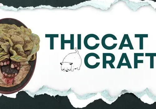 Oval sculpture of a snarling lettuce face, "THICCAT CRAFTS," a chubby cat drawing—unique art from ThicCatCrafts.