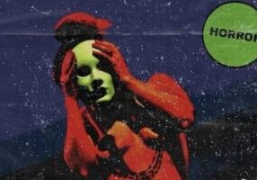 This is an antique horror film poster. The eerie design showcases a character with green skin, draped in a red cloak, gripping a skull against the backdrop of a starlit night. A green tag in the corner labels it as 'horror.'