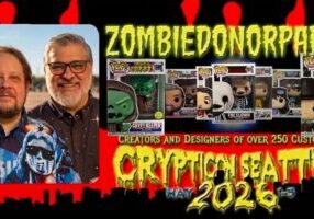 Two men smiling beside a display of custom Funko Pop toys with bold text promoting Cryptic Death 3 in May 2026.